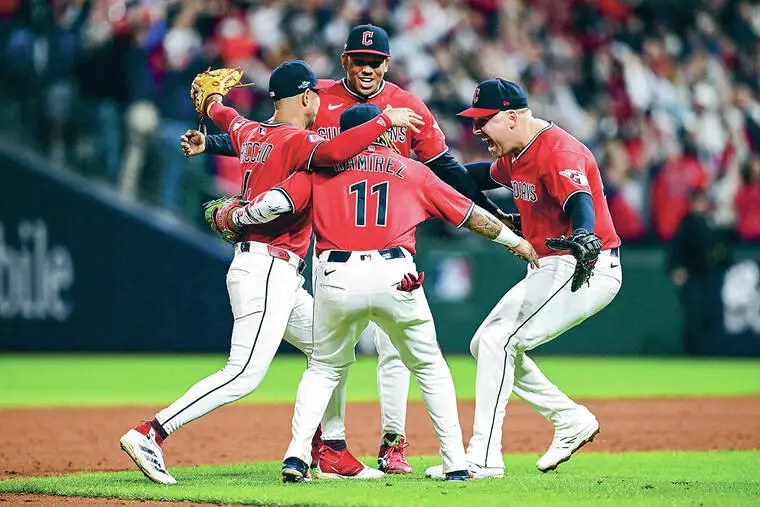 José Ramírez, wearing No. 11, celebrates with Guardians teammates on the infield at Progressive Field